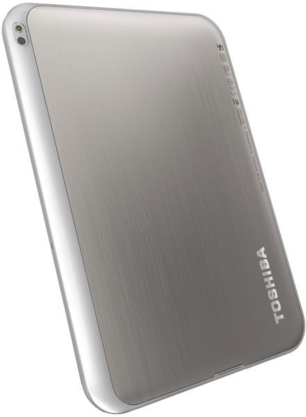 Toshiba tablet rear angled view, silver metallic finish, rounded edges, Toshiba logo on lower right. Model not specified.