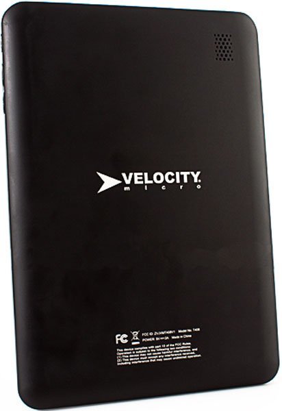 Rear view of black Velocity Micro tablet with logo, regulatory info, and small upper-right speaker grille visible.