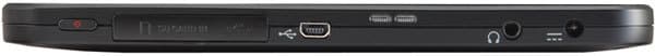 Side edge close-up of black tablet with USB port, headphone jack, and two small buttons; brand and model not identifiable.