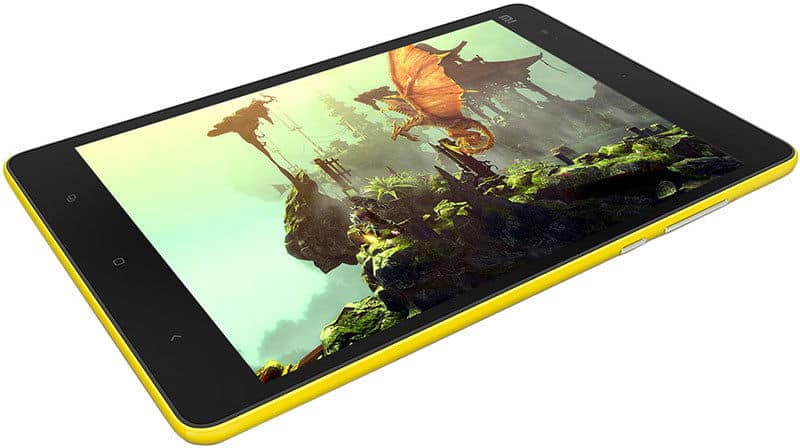 Yellow tablet angled to show front display, screen on with vibrant fantasy scene—dragon flying over green rocks and ruins.