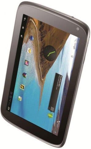 Black-framed tablet, angled front view; home screen shows app icons, clock widget, and coastal wallpaper with blue water.