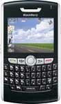 BlackBerry 8820 front view with landscape photo on screen and QWERTY keyboard below