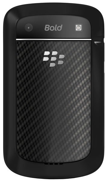 Rear view of BlackBerry Bold 9900 with textured black panel, silver logo, top corner camera lens, and flash.