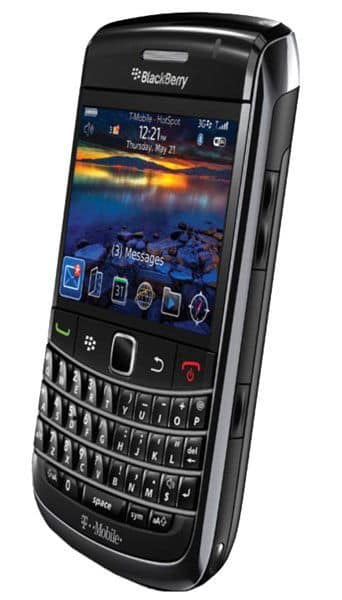 BlackBerry Bold 9700 front view, black smartphone with illuminated screen displaying landscape photo, physical QWERTY keyboard below