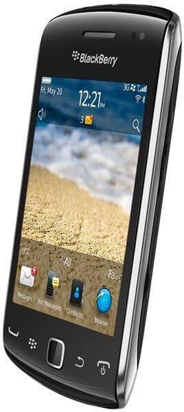 BlackBerry Curve 9380 front view, black smartphone with touchscreen displaying beach scene and time 12:21