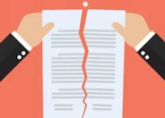 Two hands tearing apart a document with a red jagged line down the middle against an orange background