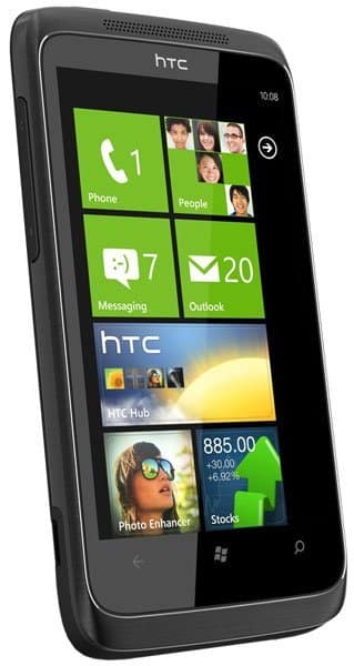 HTC 7 Trophy front view displaying Windows Phone home screen with app tiles including Phone, People, Messaging, and Outlook