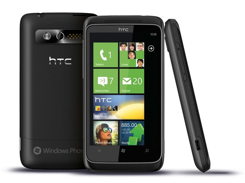 HTC 7 Trophy front, back, and side views showing Windows Phone home screen with colorful app tiles and camera on back