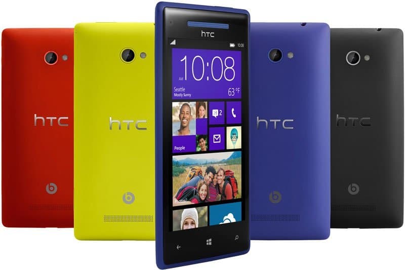 HTC Windows Phone 8X shown front-facing in blue, others rear view in red, yellow, and black with HTC and Beats logos visible.