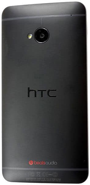 HTC One rear view in black, featuring HTC logo, rear camera with flash, and Beats Audio branding at the bottom.