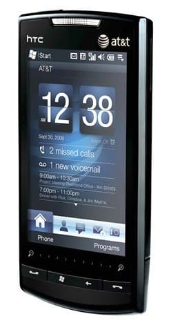 Front view of black HTC Pure with AT&T logo, home screen showing 12:38, Sept 30, 2009, and call/voicemail notifications.