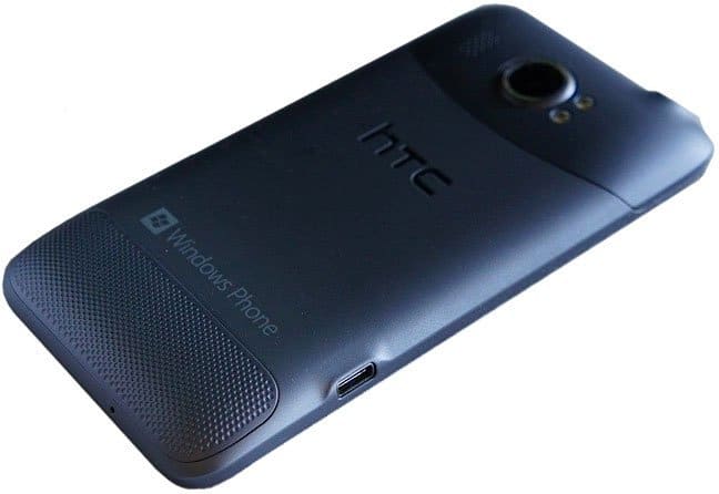 HTC Titan II rear view, dark blue phone with camera lens and textured speaker grille at bottom