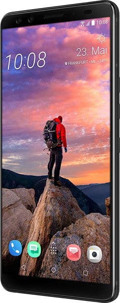 HTC U12+ front view displaying landscape wallpaper with hiker on rocky mountain peak at sunset