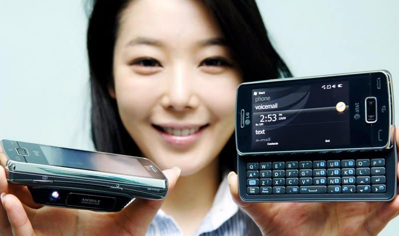 Woman holding LG IQ (eXpo) phone with sliding QWERTY keyboard, front and side views displayed