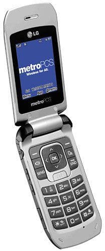 LG Select flip phone, open, displaying Metro PCS home screen with numeric keypad visible below