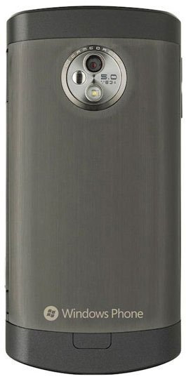 Rear view of LG Optimus 7 showing brushed metal finish, 5MP camera, LED flash, and Windows Phone logo at bottom.