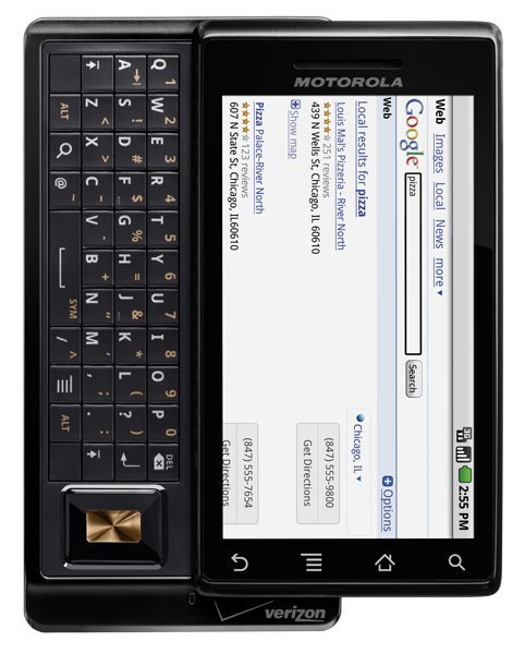 Front view of Motorola Milestone with slide-out QWERTY keyboard, Google search for pizza on screen, Verizon logo at bottom.