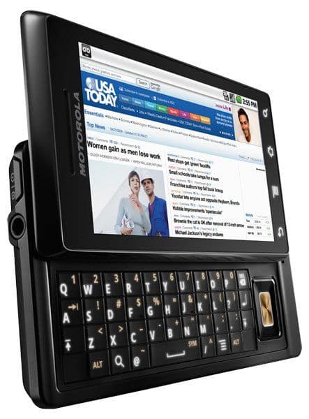 Motorola Milestone (left-side view) with slide-out QWERTY keyboard, screen showing USA Today news website.