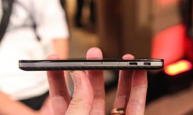 Motorola DROID RAZR MAXX HD, side view, held in hand showing slim profile with ports visible along edge