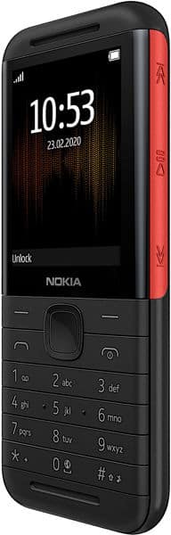 Nokia 5310 (2020) front view with black body, red side accent, and numeric keypad displayed on screen showing 10:53