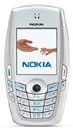 Nokia 6620 front view showing silver casing, small screen displaying Nokia branding, and numeric keypad below