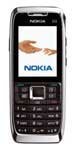 Nokia E51 front view, black and silver candybar phone with screen displaying Nokia logo and numeric keypad below