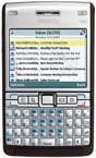 Front view of Nokia E61i, showing small color screen with email inbox and physical QWERTY keyboard below.