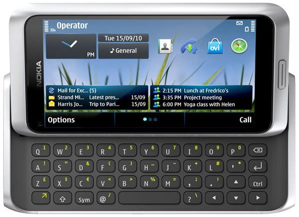 Front view of Nokia E7 with slide-out QWERTY keyboard extended, displaying home screen with email and calendar alerts.