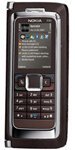 Nokia E90 communicator phone with slide-open QWERTY keyboard, shown from front view displaying keypad and screen