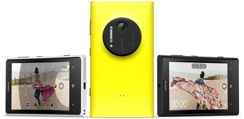 Nokia Lumia 1020 rear view, yellow with large circular camera lens, flanked by white and black phones displaying photos