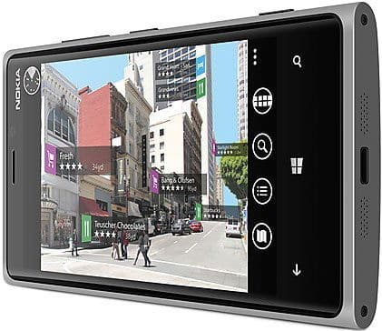 Front view of Nokia Lumia 920 displaying augmented reality, overlaying city street with business info and ratings.