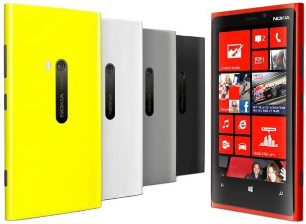 Five Nokia Lumia phones shown: yellow, white, gray, black (rear view), and red Lumia 920 (front with Windows Phone home screen).