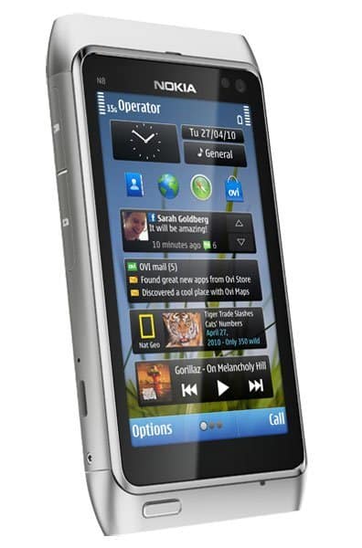 Nokia N8 front view with screen displaying home interface, clock, messages, and music player controls
