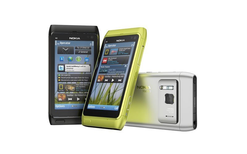 Nokia N8 phones in black, lime green, and silver, displayed from front and rear angles showing screens and camera lens