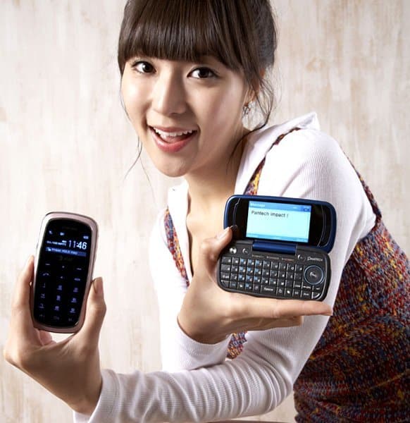 Woman holding two Pantech Impact phones, displaying the front screen and keypad design of the device