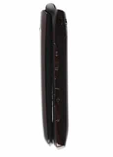 Black PCD Escapade flip phone in closed position, side view highlighting hinge and visible side buttons.