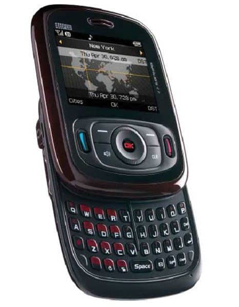 Front view of the PCD TXTM8 slider phone showing its QWERTY keyboard, navigation keys, and small display with world clock.