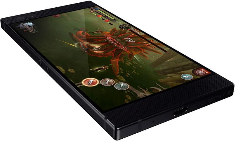 Razer Phone displaying a fantasy game with a red dragon enemy and game UI elements on its screen, viewed from the front at an angle