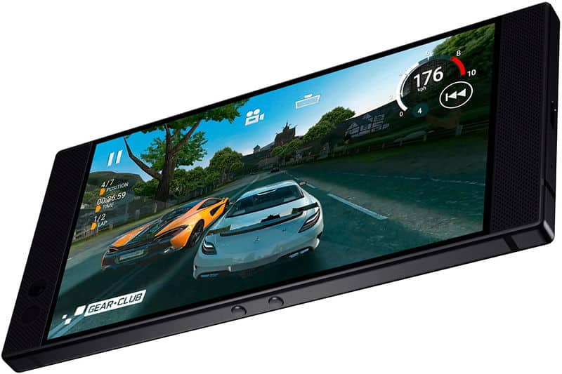 Razer Phone displaying a racing game with two sports cars on a scenic road, shown from a tilted front angle with the screen active