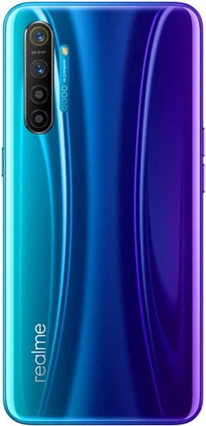 Rear view of Realme X2 showing gradient blue-purple back, vertical quad cameras, and "realme" logo in lower left.