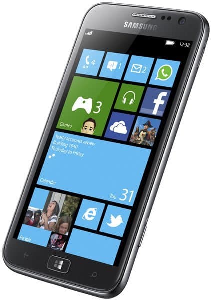Samsung Ativ S smartphone front view, displaying Windows Phone home screen with colorful tile icons for apps and calendar notifications