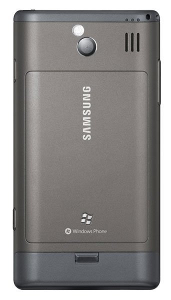 Samsung Omnia 7 rear view, showing gray metallic back panel with camera, Samsung branding, and Windows Phone logo