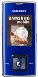 Samsung J600 mobile phone, front view, blue exterior with small screen and camera lens visible