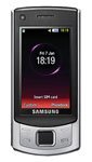 Samsung S7350 mobile phone, front view, with silver casing and black screen displaying time and date