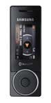 Samsung X830 mobile phone, front view, with screen displaying menu interface and circular navigation dial below