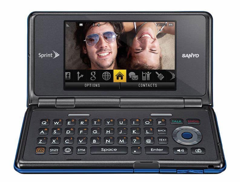 Sanyo Innuendo open front view, showing landscape screen with two smiling people, QWERTY keyboard, and Sprint branding