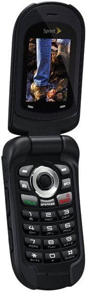 Sanyo Taho flip phone, open, showing rugged black exterior with circular camera lens and numeric keypad below glowing screen above