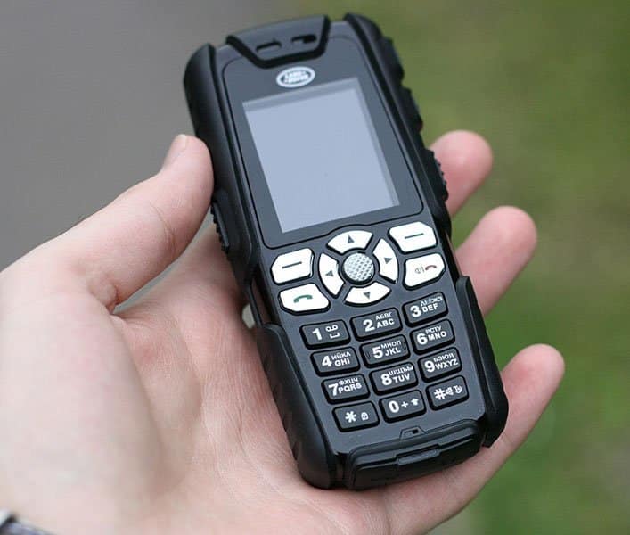 Sonim Land Rover S1 rugged phone held in hand, front view, with small screen and physical keypad