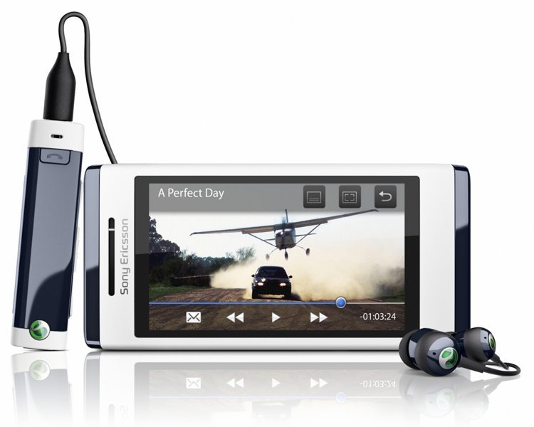 Sony Ericsson Aino front view displaying video playback on screen, with attached headphones and charging cable visible