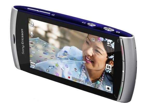 Sony Ericsson Vivaz phone, front view, displaying photo of woman and child on screen with camera interface visible